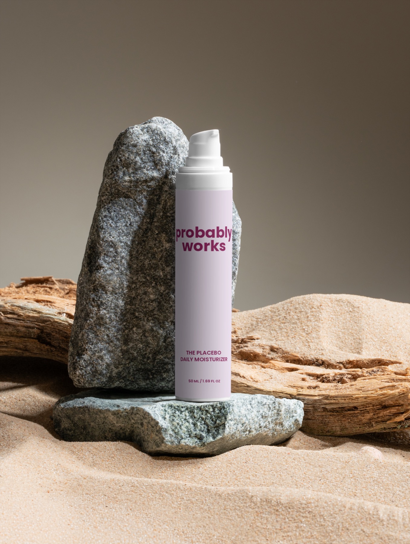 The Placebo Daily Moisturizer standing on stone, sand, and driftwood