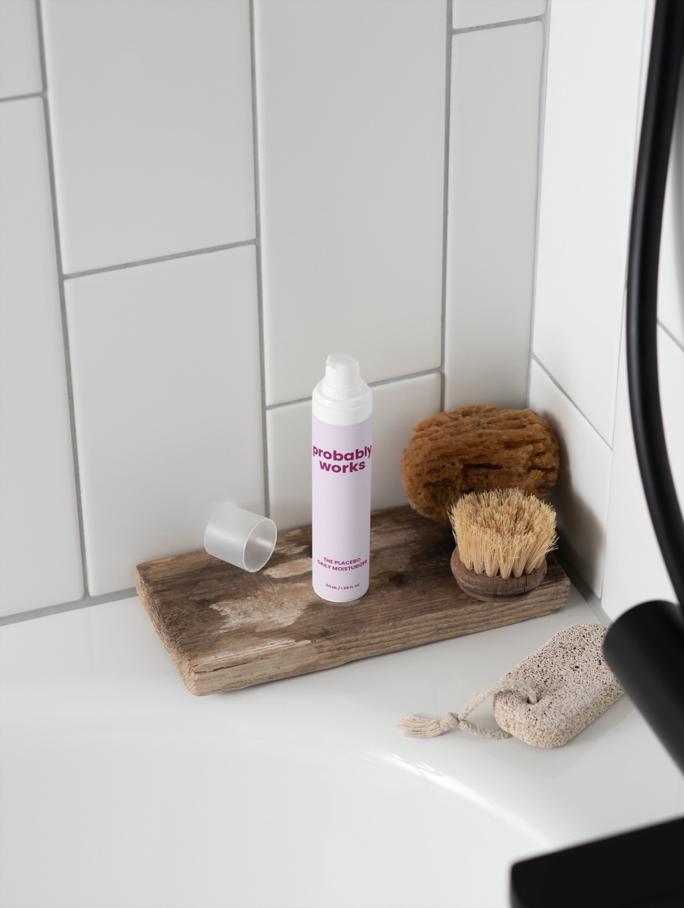 The Placebo Daily Moisturizer on a shower ledge with bath tools