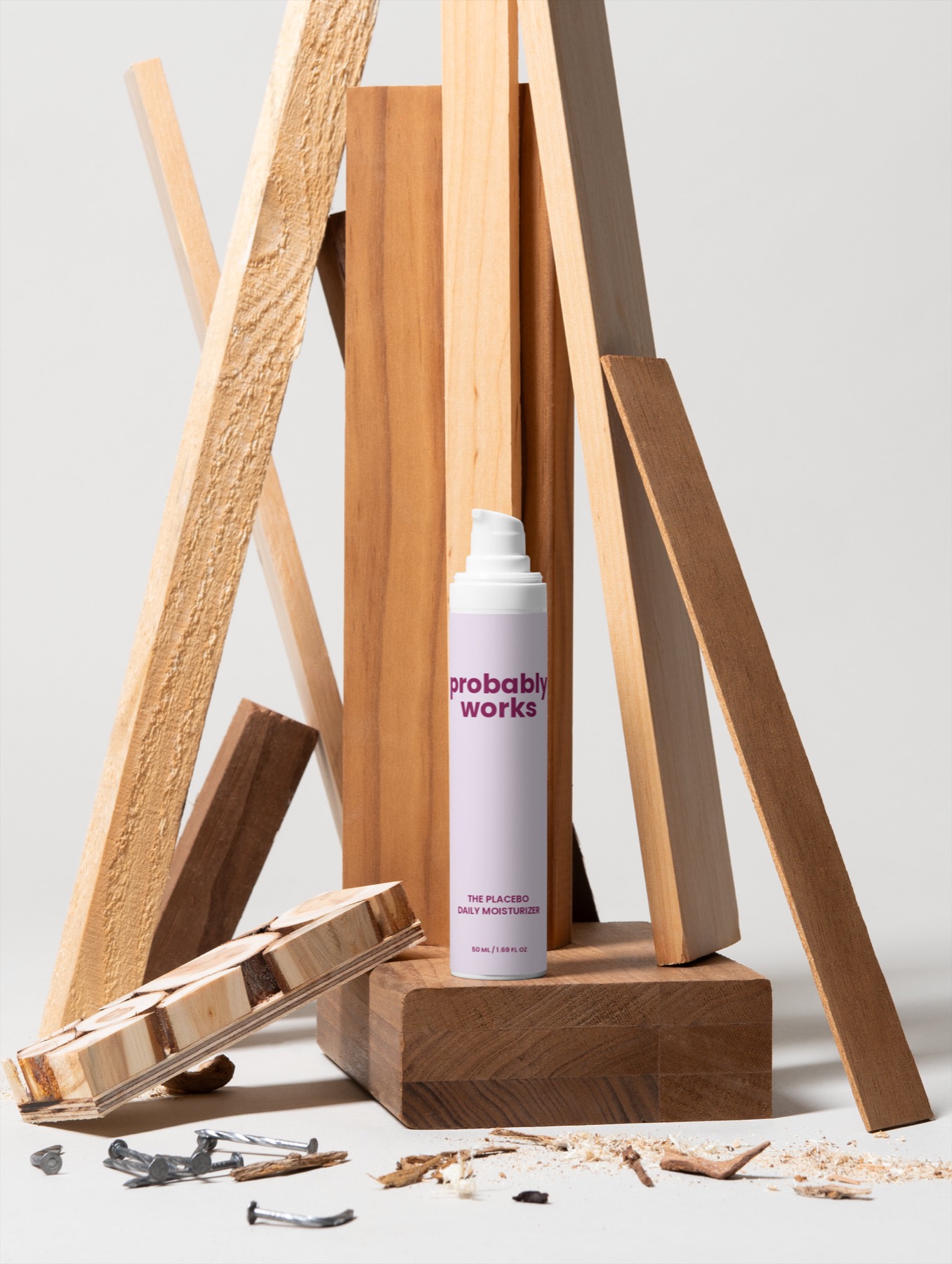 The Placebo Daily Moisturizer surrounded by stacked wood pieces